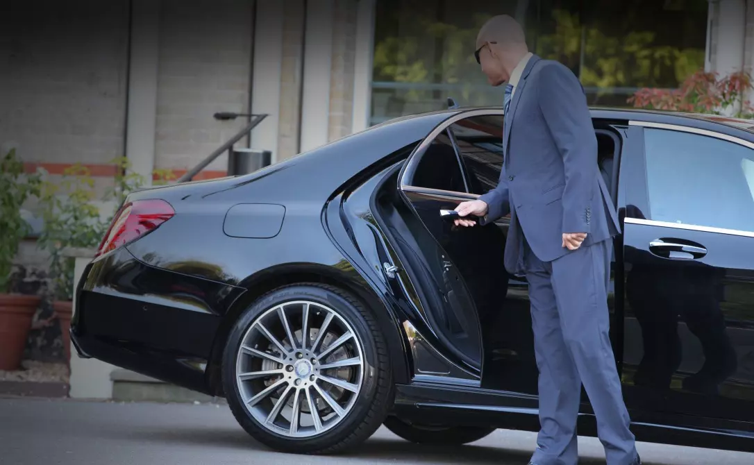 Professional London chauffeur assisting executive recruitment candidates with business travel